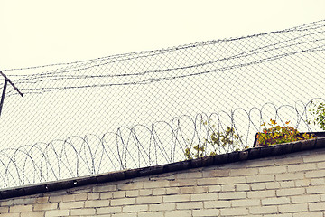 Image showing barb wire fence over gray sky