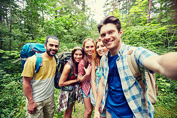 Image showing friends with backpack taking selfie in wood