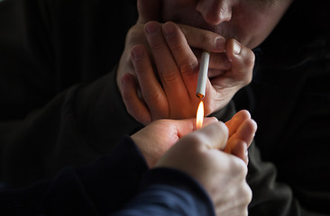 Image showing close up of young people smoking cigarette