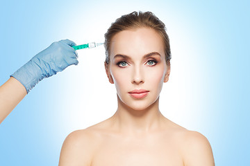 Image showing woman face and hand with syringe making injection