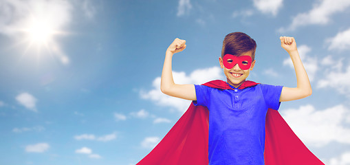 Image showing boy in red superhero cape and mask showing fists