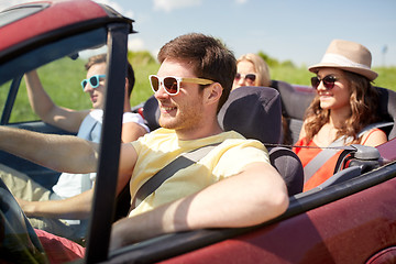 Image showing happy friends driving in cabriolet car