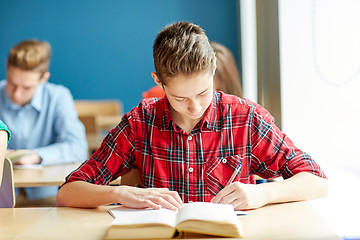 Image showing group of students with books writing school test