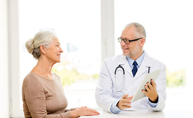 Image showing smiling senior woman and doctor with tablet pc