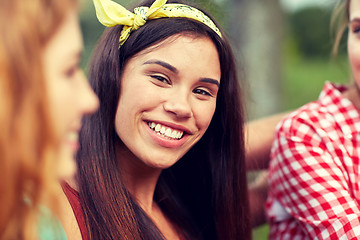 Image showing happy young woman with group of friends outdoors