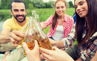 Image showing happy friends with tent and drinks at campsite