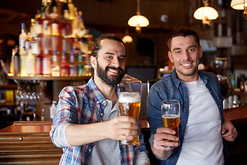 Image showing happy male friends drinking beer at bar or pub