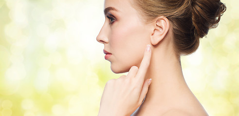 Image showing beautiful woman pointing finger to her ear