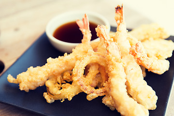 Image showing close up of deep-fried shrimps and soy sauce