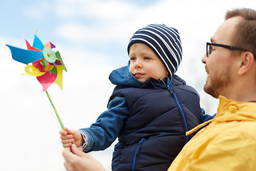 Image showing happy father and son with pinwheel toy outdoors