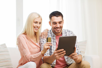 Image showing happy couple with tablet pc and credit card