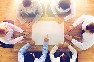 Image showing close up of business team with paper at table