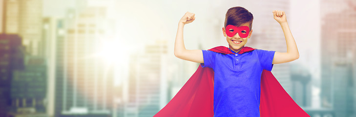 Image showing boy in red superhero cape and mask showing fists