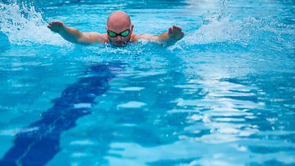 Image showing Athletic swimmer training in a swimming pool