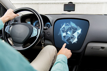Image showing man driving car and pointing to on-board computer