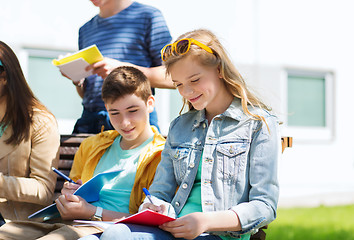 Image showing group of students with notebooks at school yard