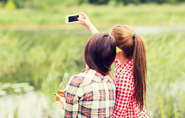 Image showing happy women taking selfie by smartphone outdoors