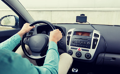 Image showing close up of young man driving car