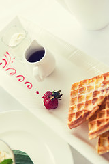Image showing close up of waffles on plate at breakfast table