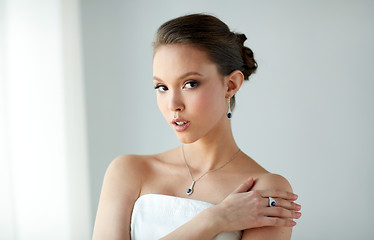 Image showing beautiful woman with earring, ring and pendant