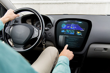 Image showing close up of man driving car with navigation system