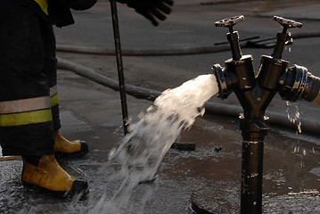 Image showing Hydrant and fireman