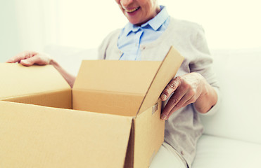 Image showing close up of senior woman with parcel box at home