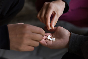 Image showing close up of addicts using drug pills