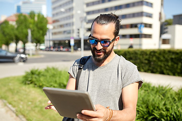 Image showing man traveling with backpack and tablet pc in city