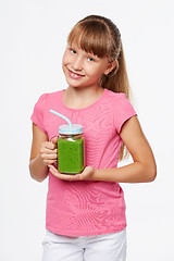 Image showing Girl holding jar tumbler mug with green smoothie drink