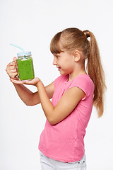 Image showing Girl holding jar tumbler mug with green smoothie drink