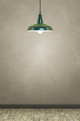 Image showing green lamp in front of a brown wall