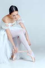 Image showing Professional ballerina putting on her ballet shoes