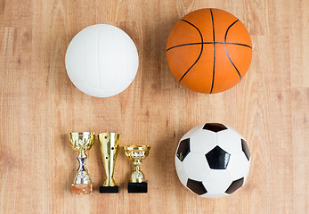 Image showing football, basketball, volleyball balls and cups