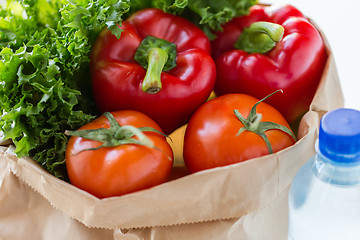 Image showing close up of paper bag with vegetables and water