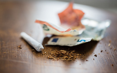 Image showing close up of marijuana joint and money