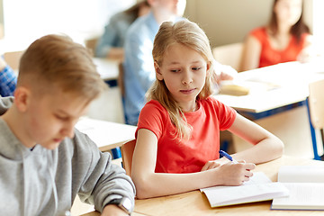 Image showing group of students with books writing school test