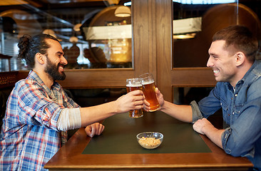 Image showing happy male friends drinking beer at bar or pub