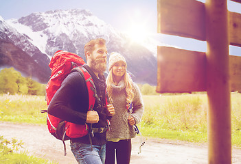 Image showing smiling couple with backpacks hiking