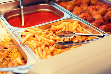 Image showing close up french fries of and other dishes on tray