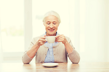 Image showing happy senior woman with cup of coffee