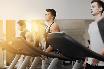 Image showing group of men exercising on treadmill in gym