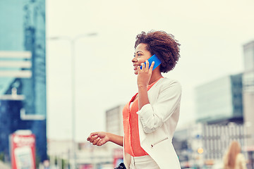 Image showing happy african businesswoman calling on smartphone