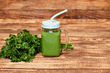 Image showing Mug with green smoothie drink and bundle of fresh parsley