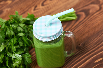 Image showing Mug with green smoothie drink and bundle of fresh parsley