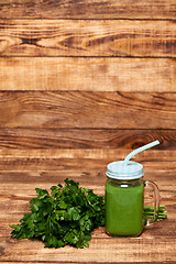 Image showing Mug with green smoothie drink and bundle of fresh parsley