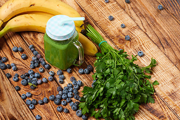Image showing Mug with green smoothie drink and bundle of fresh parsley