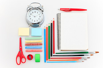 Image showing School set with notebooks, pencils, brush, scissors and apple on white background