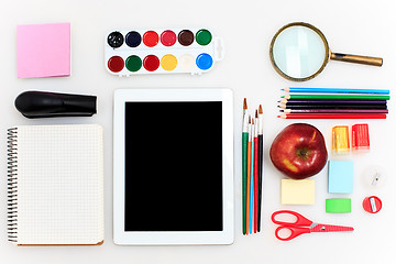 Image showing School set with notebooks, pencils, brush, scissors and apple on white background