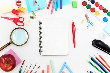 Image showing School set with notebooks, pencils, brush, scissors and apple on white background